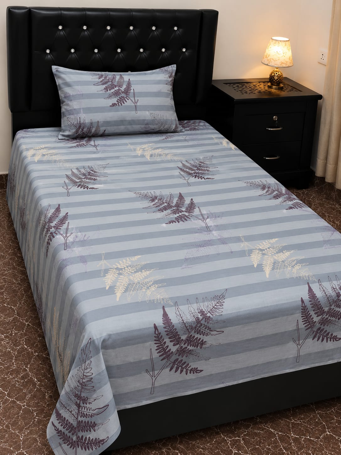 Gray and white striped bed sheets with fern pattern
