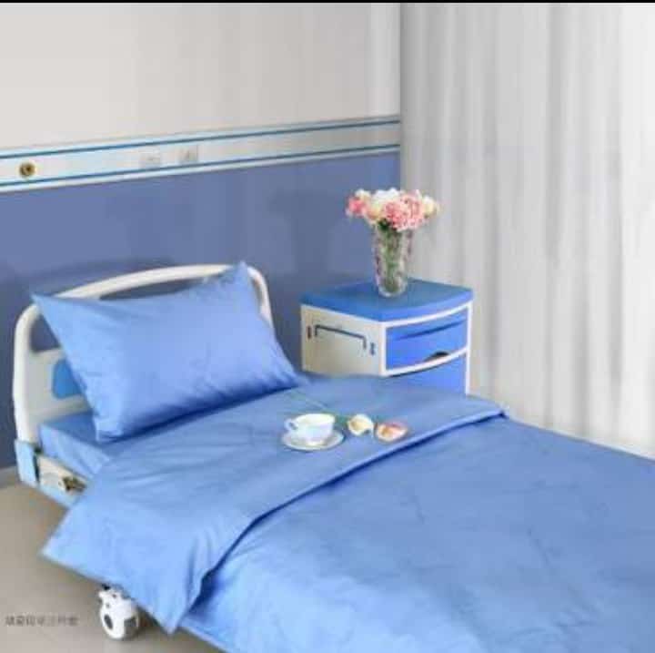 Hospital bed with blue medical linens